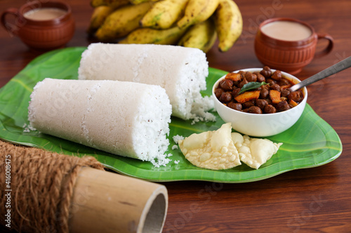 Rice Puttu white Pittu , Kadala Chickpea curry , milk tea , popular South Indian breakfast steamed rice cake Kerala food Tamil Nadu India Sri Lanka. rice flour grated coconut