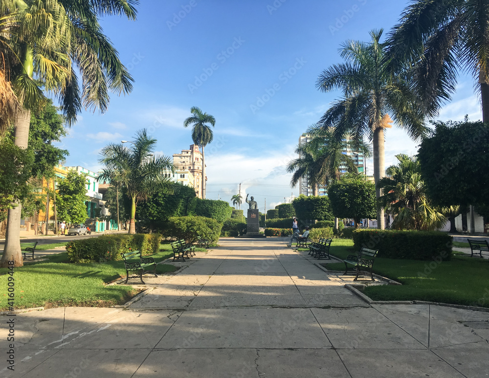Pedestrian area of ​​Avenue of Presidents in the Vedado neighborhood in Havana with the monument to Salvador Allende in the background.