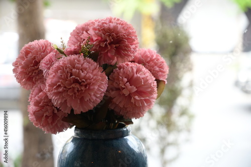 fake flower peony blooming in vase