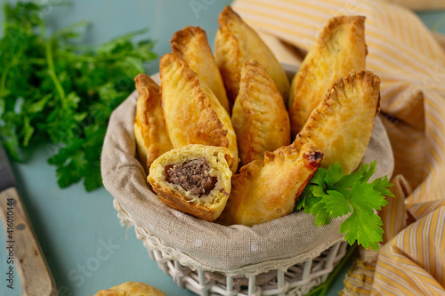 Traditional Lithuanian savoury pastries Kibinai filled with ground meat and onions photo