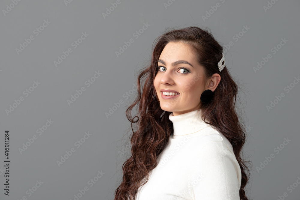 portrait of beautiful sensual woman with long curly hair against gray background portrait of beautiful sensual woman with long curly hair against gray background