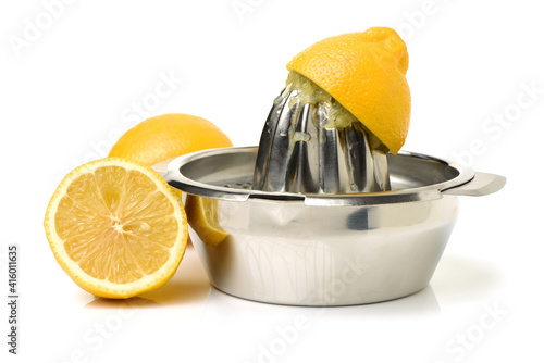 yellow lemon and lemon-squeezer on white background