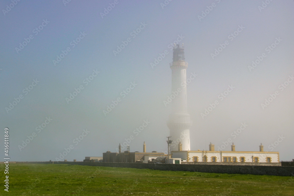 Girdleness Lighthouse emerging through thinning fog on an early spring morning