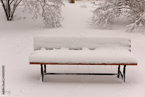 Wallpaper Mural A bench in a winter park covered with fluffy snow. Torontodigital.ca