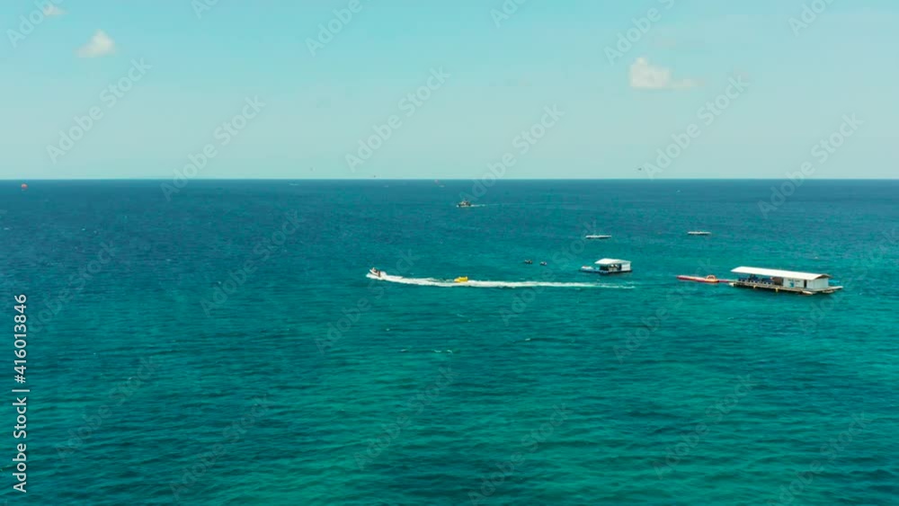 Water park on the island of Boracay, inflatable banana, jet ski, parasailing. Water sports and recreation on a tropical island. Water Activities. Sea attraction Water park on the island of Boracay, inflatable banana, jet ski, parasailing. Water sports and recreation on a tropical island. Water Activities. Sea attraction