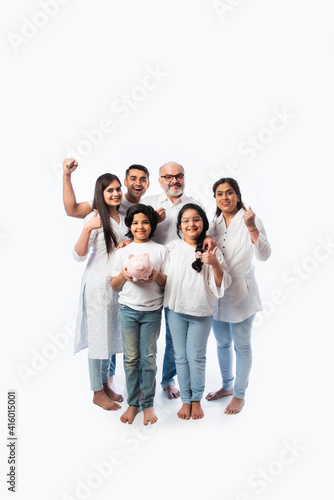 Obraz na płótnie Indian family with piggy bank standing or sitting isolated against white