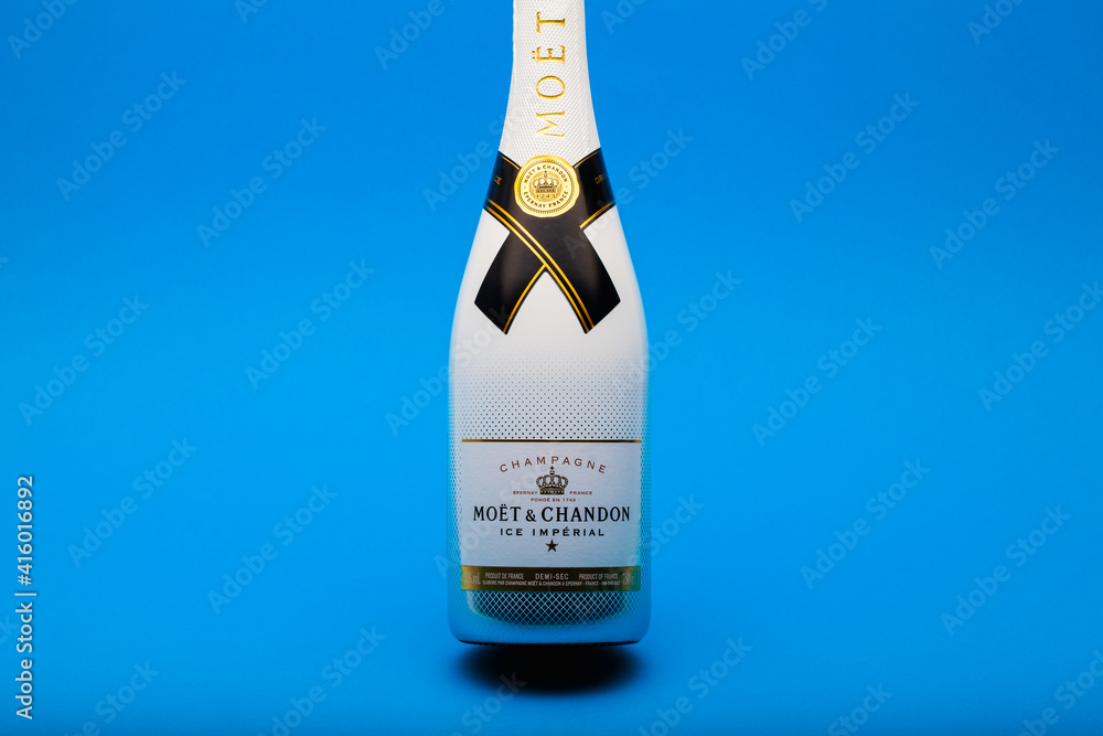 Bottle of Moet and Chandon Champagne on the blue background. Stock Photo