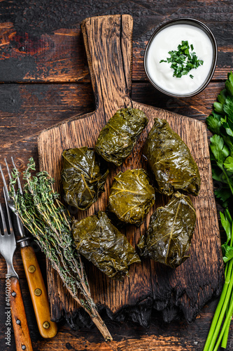 Dolma traditional Caucasian, Turkish and Greek cuisine. Dark wooden background. Top view photo