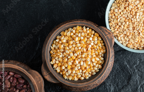 Different kinds of uncooked beans on ancient pots