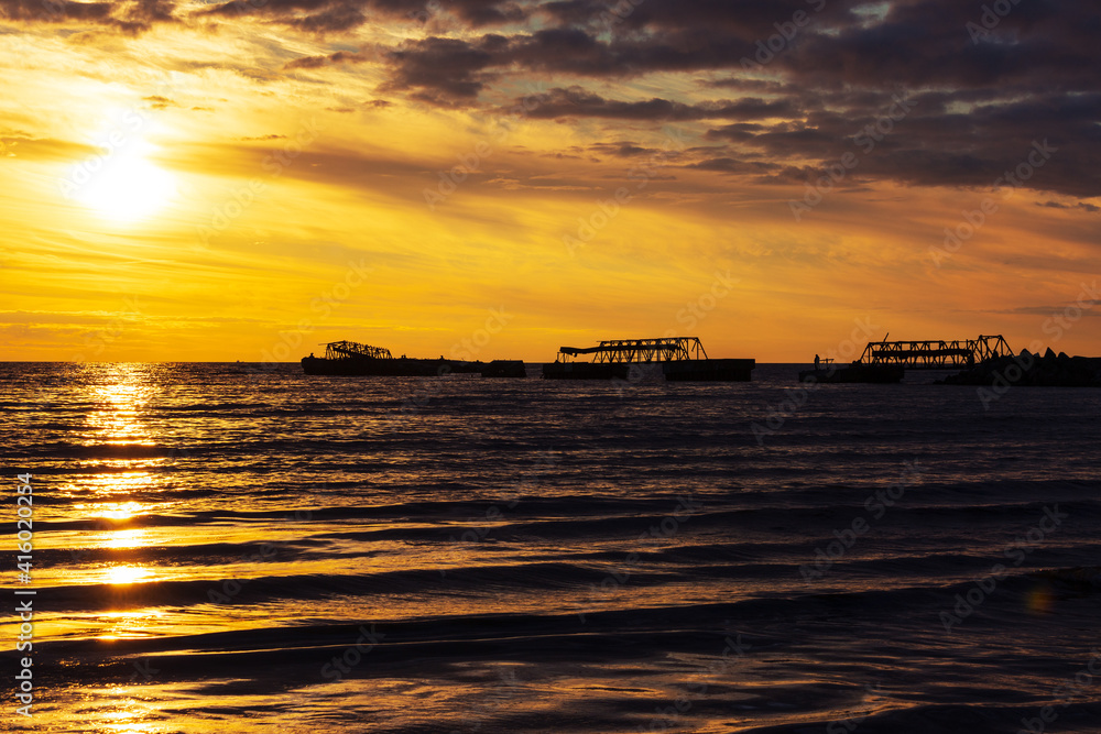 sunset on the baltic sea over abandoned pier, Russia