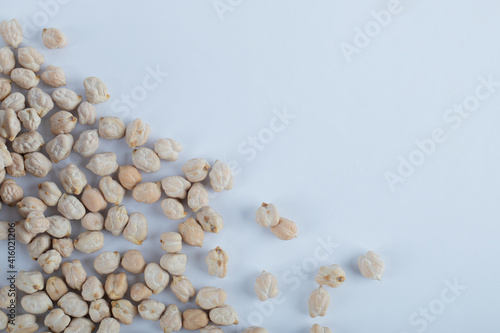 Some of white unprepared peas on a white background