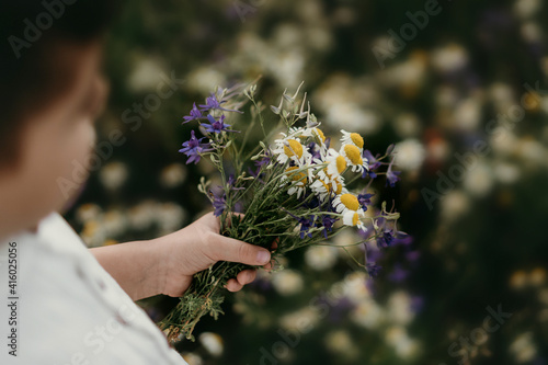 bouquet of wild flowers in a child's hand