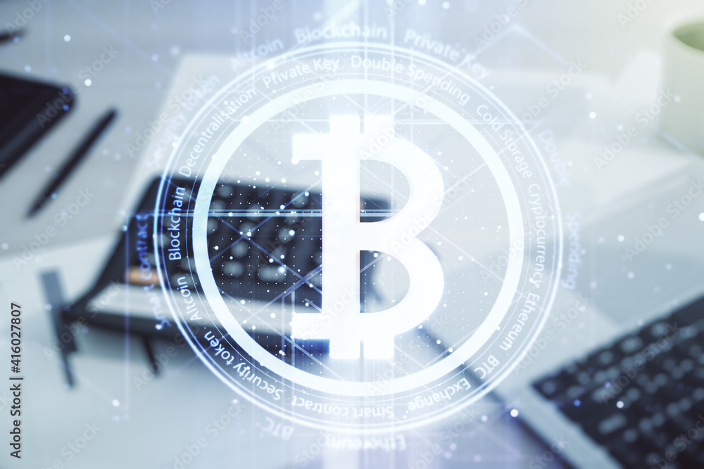 Double exposure of creative Bitcoin symbol hologram on blurry calculator with laptop background. Cryptocurrency concept Double exposure of creative Bitcoin symbol hologram on blurry calculator with laptop background. Cryptocurrency concept