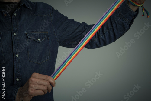 man hand with a rainbow ribbon