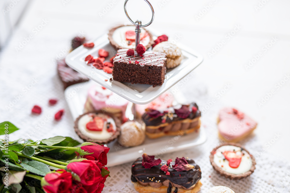 beautiful tasty romantic selection of pink chocolate love heart shape cakes for wedding, mothers day, valentines day, spring flower biscuits tartlet and rose petals beautiful tasty romantic selection of pink chocolate love heart shape cakes for wedding, mothers day, valentines day, spring flower biscuits tartlet and rose petals