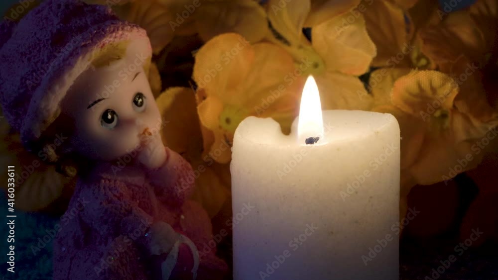 candle burning at night,doll with a burning candle at night candle burning at night,doll with a burning candle at night