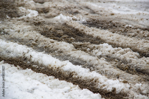 Tablou pe pânză Dirty snow mixed with clean on the road