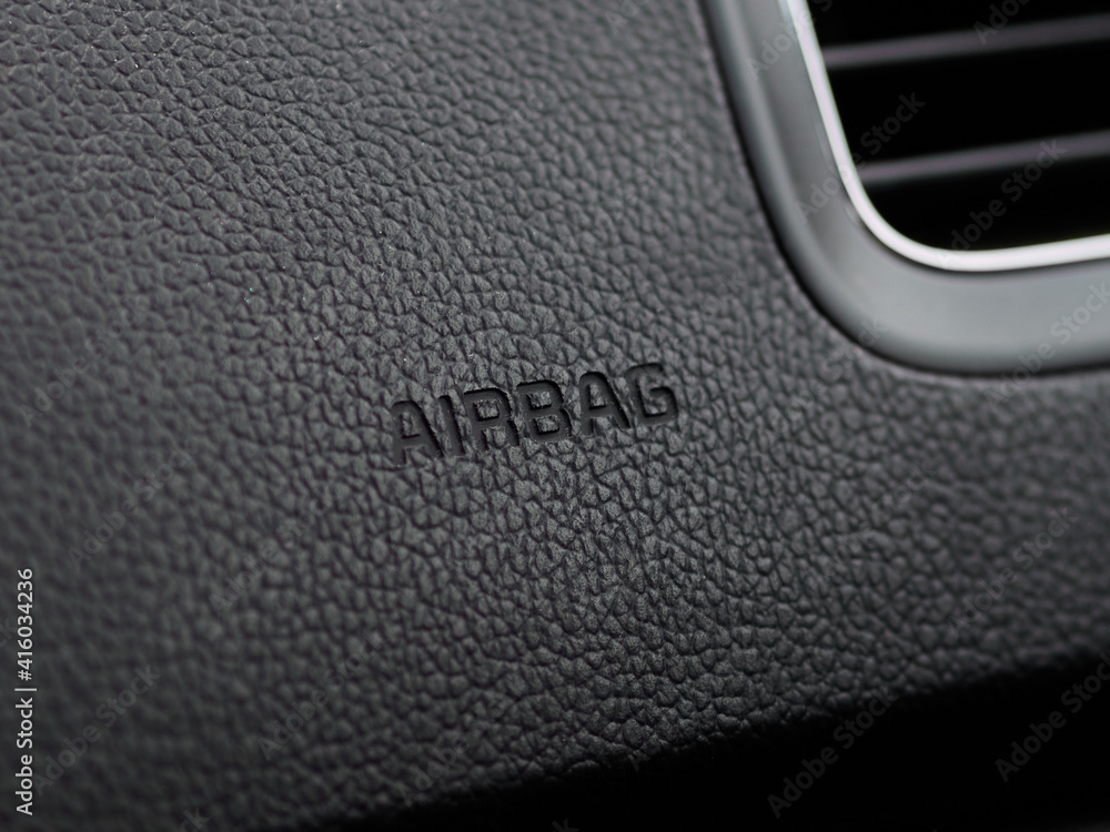 Detailed closeup image of a dashboard airbag zone work in interior of modern car. Sign Airbag. Detailed closeup image of a dashboard airbag zone work in interior of modern car. Sign Airbag.