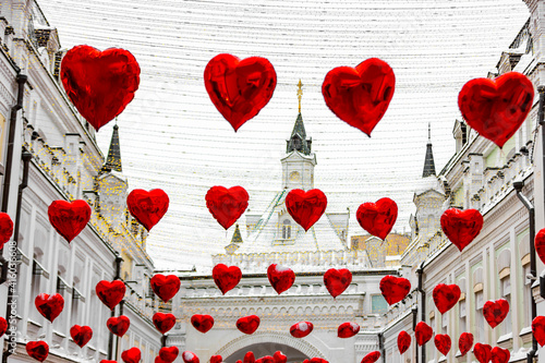 Valentine's Day. Street is decorated with red balloons in the shape of hearts.