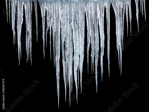 roup of icicles isolated on black background