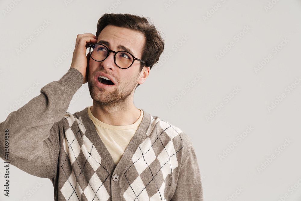 Brooding handsome guy in eyeglasses looking upward Brooding handsome guy in eyeglasses looking upward