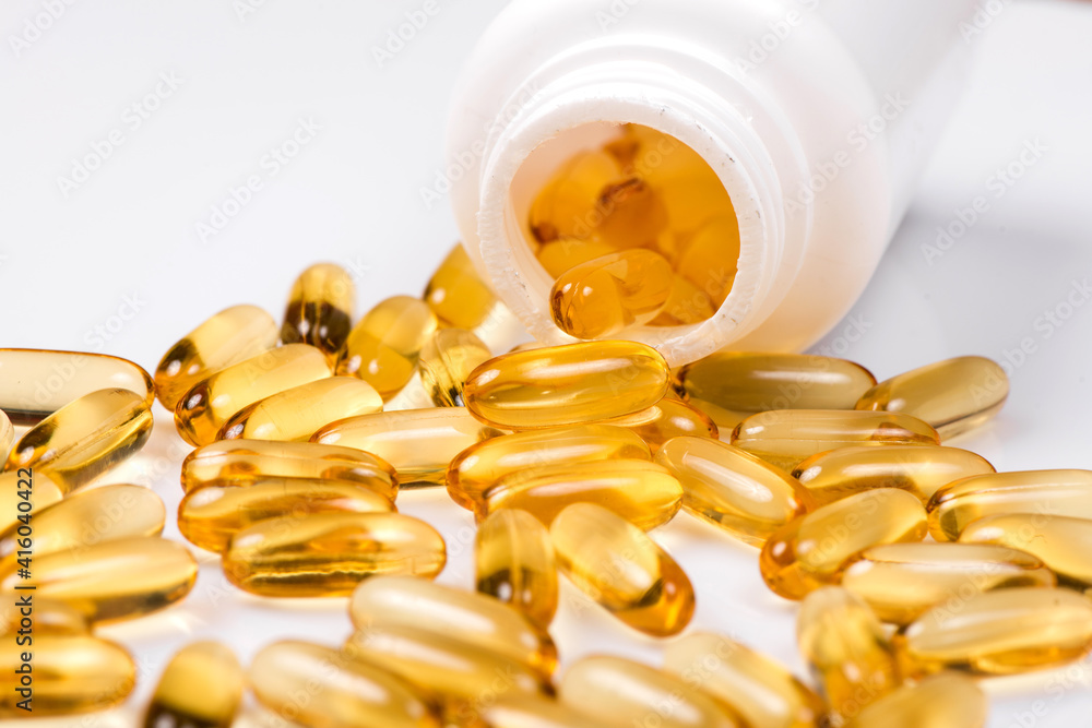 Heap of Omega 3 capsules on a white background. Top view, high resolution product. Fish fat. Heap of Omega 3 capsules on a white background. Top view, high resolution product. Fish fat.
