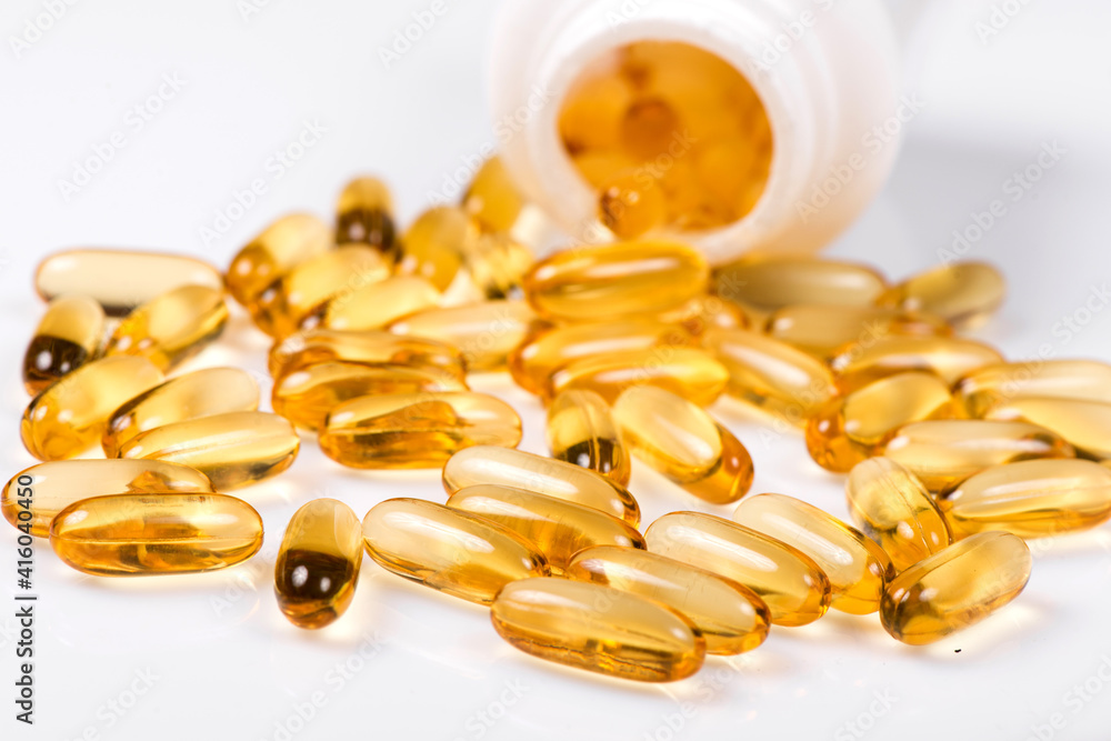 Heap of Omega 3 capsules on a white background. Top view, high resolution product. Fish fat. Heap of Omega 3 capsules on a white background. Top view, high resolution product. Fish fat.