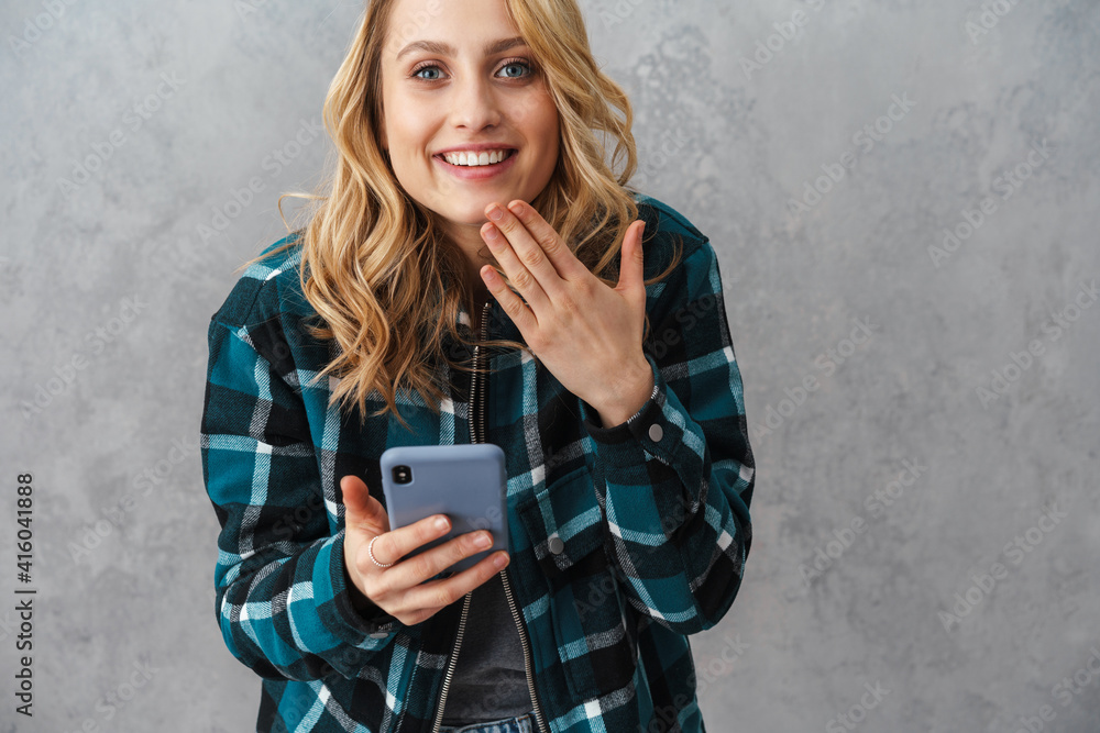 Fototapeta premium Happy beautiful woman smiling while using cellphone