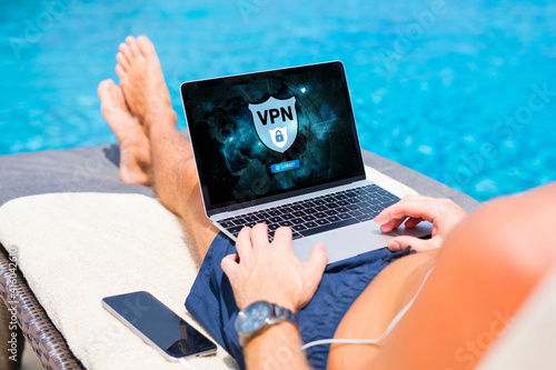 Man using VPN (Virtual Private Network) for secure and encrypted connection to internet.