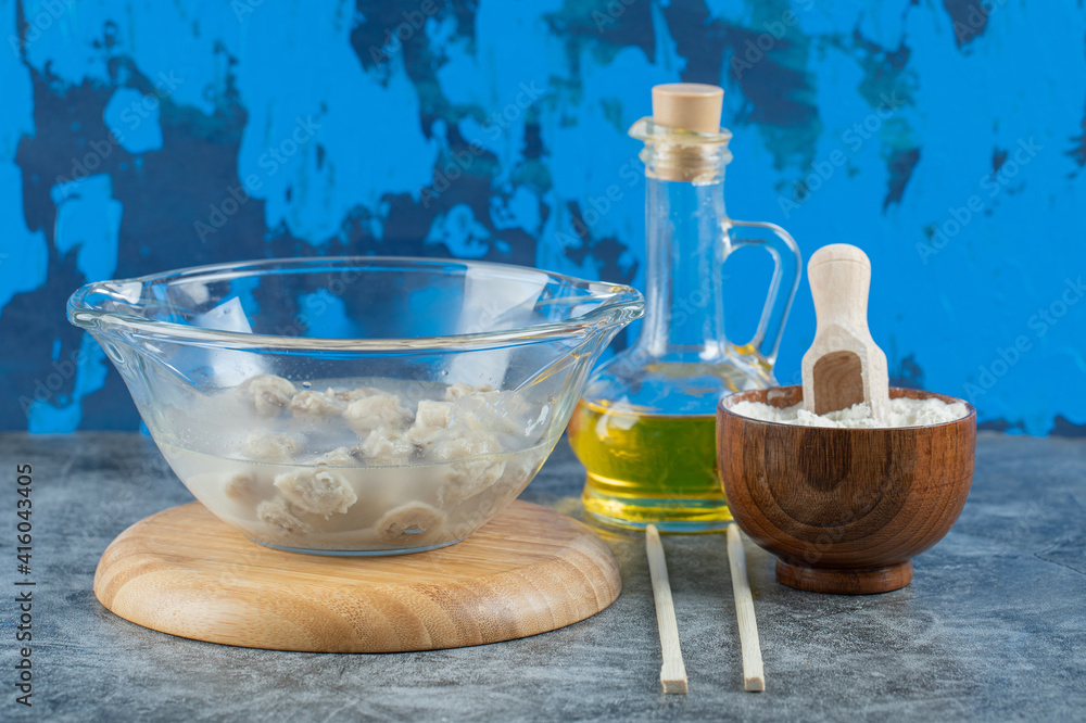A glass plate with delicious dumplings on a wooden board A glass plate with delicious dumplings on a wooden board