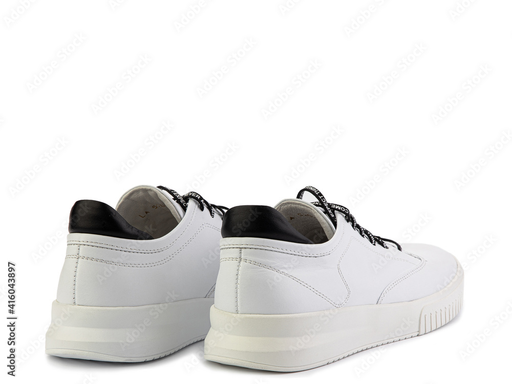 White leather sneakers. Casual women's style. Black lacing with print on it White rubber soles. Isolated close-up on white background. Back side view.