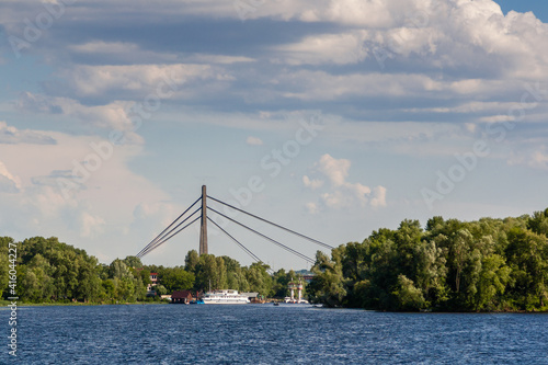 A ship that floats along the river with a view of the bridge