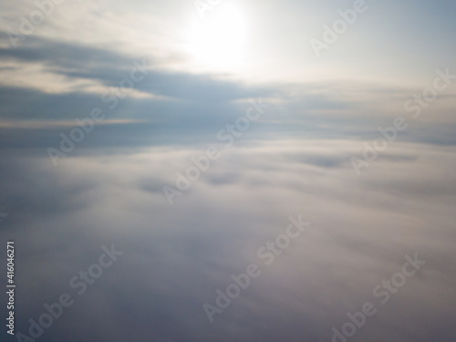 Flight high above the clouds. Aerial drone view.