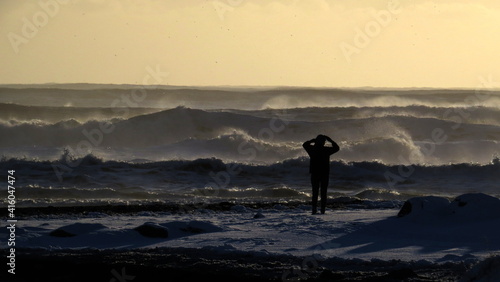 person enjoying the sunset by the atlantic ocean in iceland