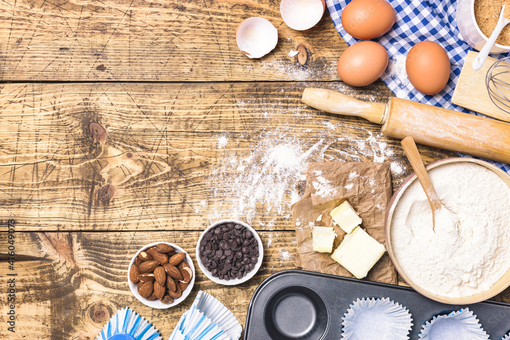 Baking and cooking ingredients on rustic wooden background Baking and cooking ingredients on rustic wooden background