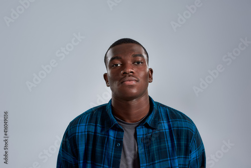Portrait of young african american man in casual shirt looking at camera