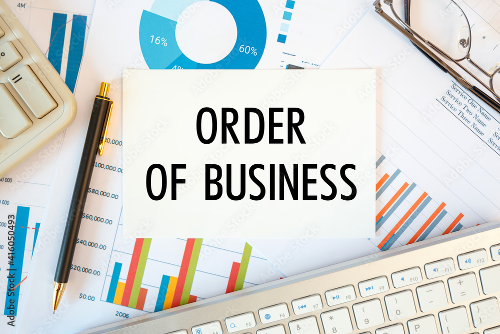 Order Of Business is written in a document on the office desk, diagram and keyboard Order Of Business is written in a document on the office desk, diagram and keyboard