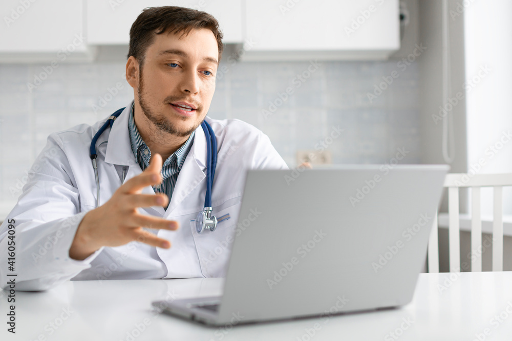 Photo of a doctor talks to the patient during an online consultation.