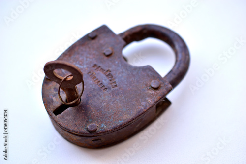 Old curtain padlock on a white background