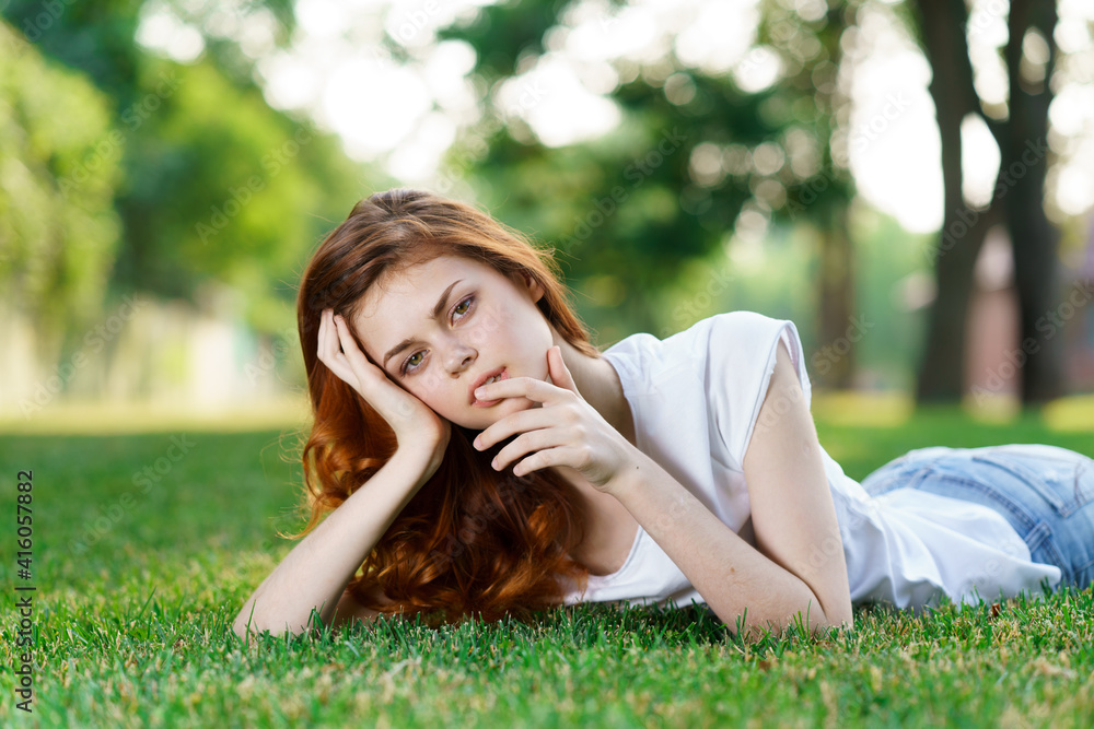 cheerful woman lies on the lawn in the park outdoors recreation cheerful woman lies on the lawn in the park outdoors recreation