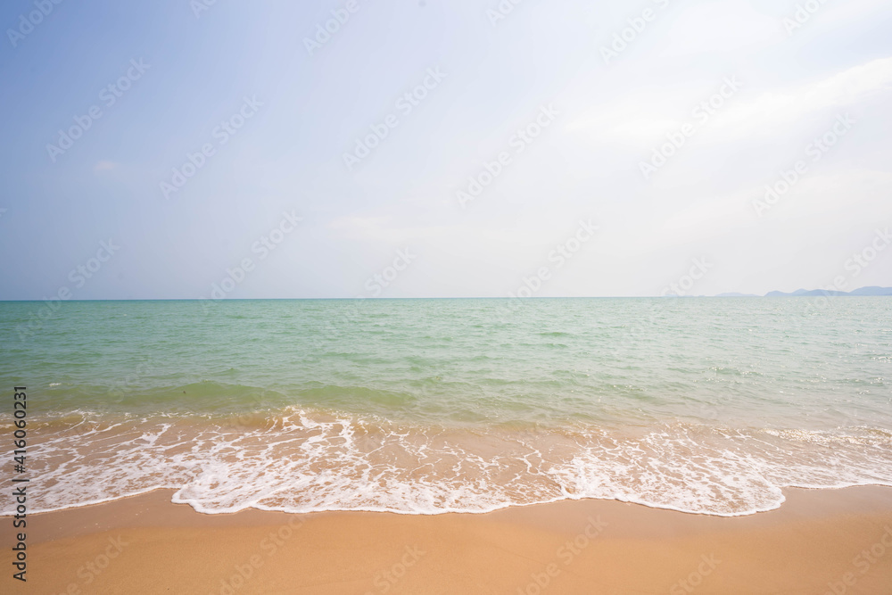White waves on a beautiful beach, sea and blue sky, sea background.