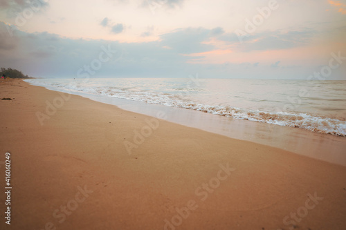 Fototapeta Naklejka Na Ścianę i Meble -  Yellow light sky and white waves on the beach in the morning, Thailand.