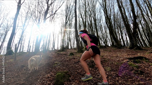 young woman trail running in the mountains photo