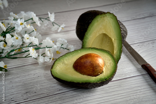 Avocado on old wooden table. Fruits healthy food concept.
