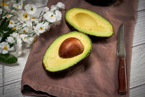 Avocado on old wooden table. Fruits healthy food concept.
