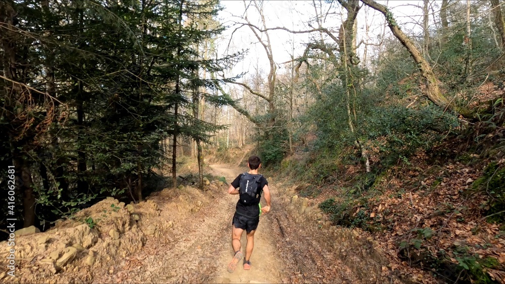 young man trail running in the mountains young man trail running in the mountains