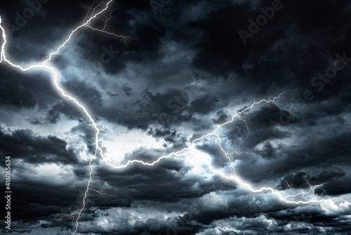 Lightning strike against the background of a cloudy dark sky. © Denis Rozhnovsky