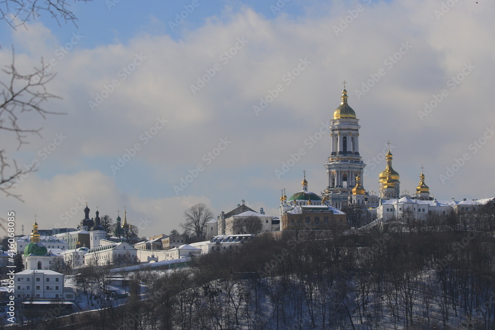 View of the large bell tower and other churches in the Kyivo-Pecherska Lavra. Kyiv. Ukraine. Kyivo-Pechersky Monastery. Winter sunny day.