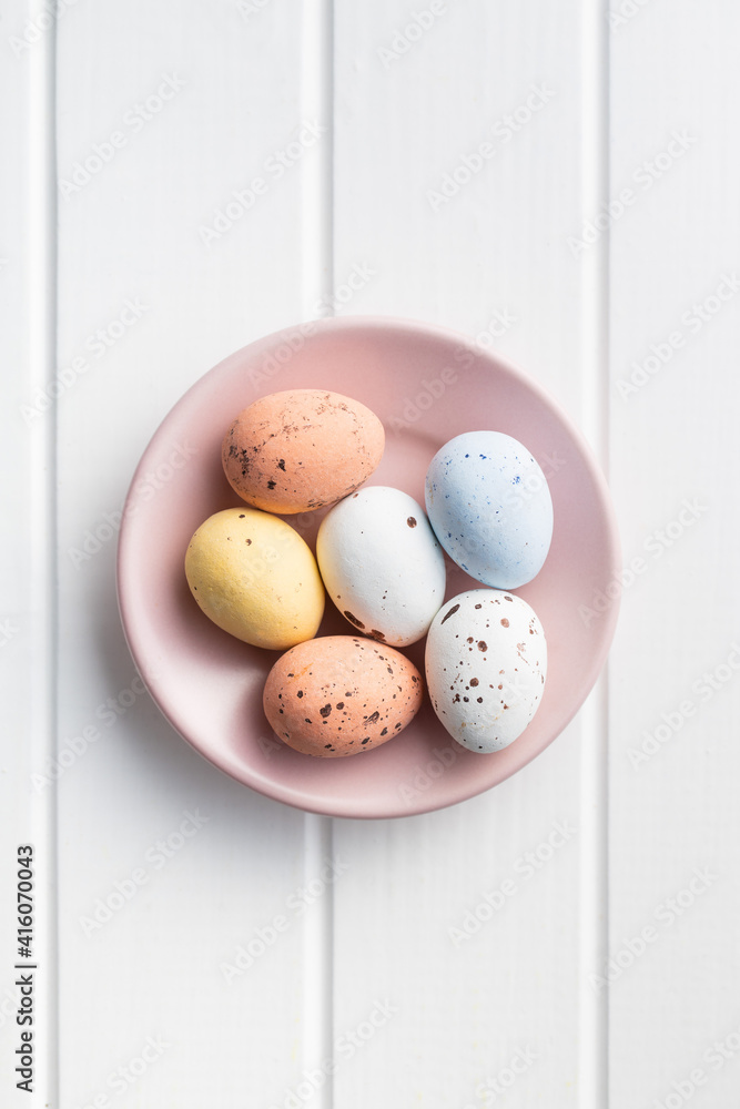 Chocolate easter eggs. Sweet candy eggs on pink plate. Chocolate easter eggs. Sweet candy eggs on pink plate.