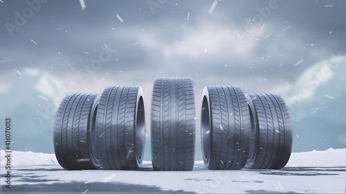 Loops car tires roll on a snowy road under the falling snow photo